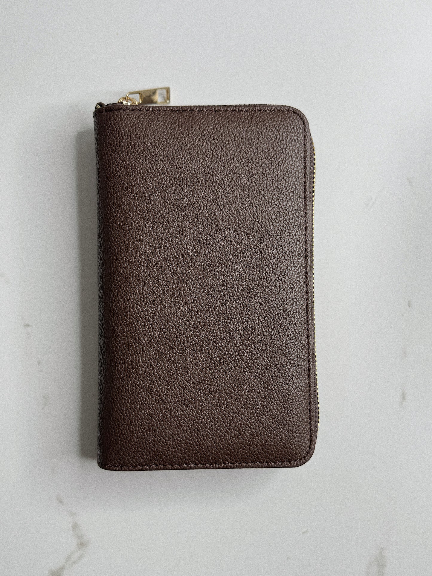 Brown leather wallet on a light gray background
