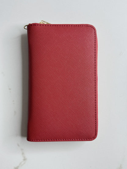 Red wallet with a gold zipper on a light gray background